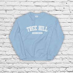 Calling all Ravens! Rep your favorite small town with a comfy Tree Hill, NC crewneck. A sturdy and warm sweatshirt bound to keep you warm in the colder months. A pre-shrunk, classic fit sweater that's made with air-jet spun yarn for a soft feel and reduced pilling. * 50% cotton, 50% polyester * Pre-shrunk * Classic fit * 1x1 athletic rib knit collar with spandex * Air-jet spun yarn with a soft feel and reduced pilling * Double-needle stitched collar, shoulders, armholes, cuffs, and hem University Sweatshirts, Tree Hill, One Tree Hill, One Tree, Cute Fits, Fitted Sweater, North Carolina, Crewneck Sweatshirt, Rib Knit