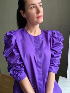 "Gorgeous vintage  blouse with wide puffy sleeves,   Silky smooth fabric. Excellent vintage condition!  Polyester.  **Tags like size 46. Please see measurements: shoulders: 36cm/14,2\", from pit to pit: 56cm/22,0\", sleeve length: 44cm/17,3\", full length: 64cm/25,2\". Measurements are taking lying flat. Model is size M and 170 cm growth. **This item will come to you freshly laundered and ready to wear. **If you want to purchase more items, please message me, I will make a special price and deli Fitted Long Sleeve Blouse With Elastic Sleeves, Elegant Puff Sleeve Top With Ruffle And Gathered Sleeves, Voluminous Blouse With Blouson Lantern Sleeves, Fall Billowy Puff Sleeve Top With Elastic Sleeves, Ruffled Long Sleeve Puff Sleeve Top, Long Sleeve Puff Sleeve Top With Ruffles, Long Sleeve Puff Top With Ruffles, Puff Sleeve Long Sleeve Top With Ruffles, Long Sleeve Puff Top With Ruffles For Work