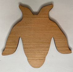 a wooden cutout of an animal's head on a white surface with no background