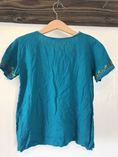 This top is in great condition and it's super soft cotton with stunning floral embroidery. It's best fitted for a 4-6 year old with measurements provided in the photos for an accurate fit. It's the perfect little hippie top to tuck into ol' Levis or bloomers ✌🏽 (5) Summer Bohemian Tunic Shirt, Bohemian Short Sleeve Tops For Spring, Green Embroidered Relaxed Fit Blouse, Spring Bohemian Embroidered Tunic Top, Bohemian Spring Embroidered Tunic Top, Green Cotton Top With Floral Embroidery, Blue Bohemian T-shirt For Summer, Bohemian Blue T-shirt For Summer, Spring Bohemian Tunic Top