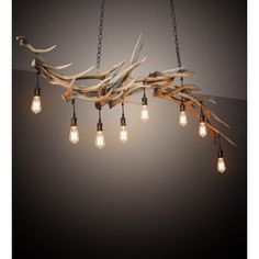 a chandelier made out of driftwood and light bulbs