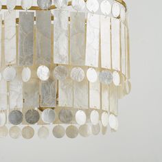 a chandelier made out of white and silver discs