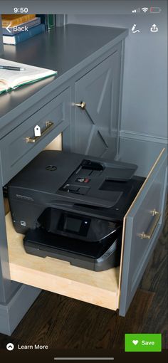 an open drawer with a printer on top of it and the bottom shelf is empty