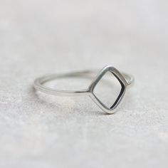 This sterling silver ring is a unique piece with an uncommon design and a gorgeous minimalistic look. If you love unusual jewelry, which you'll definitely won't see on anyone else, this Rhombus ring will become your best-loved one.The ring is 1 mm thick and is very sturdy although it looks very dainty on the finger.You see the ring of the 5.5 size in the pictures. You may order the ring of any size. If you are not sure about the size, this will be helpful: findmyringsize.com/If you want to buy t Minimalist Adjustable Ring With Diamond Cut, Minimalist Adjustable Diamond Cut Rings, Adjustable Minimalist Stackable Rings With Diamond Cut, Modern Stackable Open Rings With Single Diamond, Minimalist Stackable Diamond Ring With Open Band, Minimalist Open Band Stackable Diamond Ring, Minimalist Sterling Silver Diamond Ring With Open Band, Minimalist Stackable Rings With Diamond Cut Open Band, Minimalist Open Band Diamond Ring For Everyday