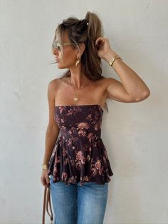 Embrace timeless elegance with the Rosy Outlook Top from Copper and Cloth! This strapless brown floral peplum top features a flattering smocked back with a zipper for the perfect fit. Whether you're dressing it up for a special occasion or keeping it casual, this top adds a touch of romance to any look. Grab yours now! Fitted Tube Top With Smocked Back For Day Out, Bandeau Top With Smocked Back For Vacation, Vacation Bandeau Top With Smocked Back, Stretch Smocked Back Sleeveless Tube Top, Stretch Sleeveless Tube Top With Smocked Back, Fitted Smocked Bodice Tube Top For Day Out, Chic Smocked Bodice Tube Top For Day Out, Strapless Stretch Top With Smocked Back, Strapless Top With Smocked Back For Day Out