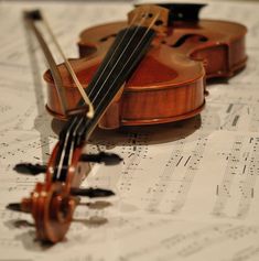 a violin laying on top of sheet music