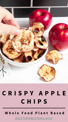 crispy apple chips in a white bowl with an apple and cinnamon on the side