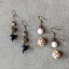 Set Of 2 Handmade Earrings In Excellent Condition! One Pair Is An Overall Black Colorway With Glass And Plastic Beads. The Other Pair Is An Overall Purple Colorway With Plastic Beads. ~2" Long. Twine And Stones Is My Handmade Jewelry Brand. Items Are Made With Repurposed Items And May Have Unique Patina. No Trades. No Modeling. Make A Reasonable Offer. Thanks! Purple Beaded Dangle Earrings With Black Beads, Purple Dangle Beaded Earrings With Black Beads, Purple Dangle Earrings With Black Beads, Wooden Bead Earrings, Hanging Beads, Seashell Earrings, Multicolor Earrings, Gold Leaf Earrings, Mother Of Pearl Earrings