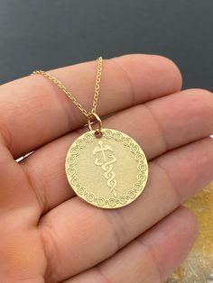 14k Solid Gold Caduceus Symbol Necklace, Personalized Medical ID Pendant, Medical Alert Pendant, Symbol of Medicine Necklace 14k Solid Gold Choose What Size You Want the Pendant Using The First Option Box Choose Chain Length Or Without Chain Using The Second Option Box Photos Are For The 25.4 mm / 1 Inch Diameter Pendant Pendant thickness : 0.7mm  Contact us if you want it thicker Inner diameter of jump ring : 5mm Contact us if you need it bigger  Chain width : 1.30mm     ♥  Material of pendant Symbolic Yellow Gold Medallion Necklace Gift, Symbolic Engraved Yellow Gold Medallion Necklace, Gold Symbolic Medallion Necklace, Symbolic Gold Medallion Necklace, Symbolic Round Medallion Necklace As Gift, Symbolic 14k Jewelry For Commemoration, 14k Gold Engraved Medallion Necklace As Gift, Personalized Symbolic Necklaces For Commemoration, Engraved 14k Gold Medallion Necklace Gift