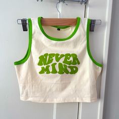 Nevermind Cream & Lime Green Crop Top Tank Top. Stretchy But True Medium. (Too Tight On Me, I Wear Large). No Brand. Never Been Worn. Stain: It’s On The Inside (Idk How It Got There), But It Kind Of Just Looks Like Dirt, Hopefully Comes Out After Washing Green Cotton Y2k Tank Top, Fitted Green Crop Top With Graphic Print, Retro Stretch Summer Tank Top, Retro Stretch Tank Top For Summer, Green Sleeveless Tank Top With Letter Print, Retro Summer Crop Top With Letter Print, Green Letter Print Sleeveless Tank Top, Retro Letter Print Crop Top For Summer, Green Sleeveless Letter Print Tank Top