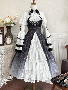 This enchanting piece features a hauntingly beautiful ombre effect that transitions from deep black to mystical shades, adorned with intricate skeleton and vine prints. The dress is complemented by a matching bell sleeves bolero, adding a touch of vintage sophistication and dramatic flair. Perfect for gothic Lolita enthusiasts.  Dress   	 		 			Size 			S 			M 			L 		 		 			Full Length 			106 			108 			110 		 		 			Bust 			86 			90 			94 		 		 			Waist 			69 			73 			77 		 	     Top   	 		 			Siz Black Dress With White Accents, Black And White Victorian Dress, Victorian Dress Design, Nobel Dresses, Egl Fashion Gothic, Witch Dress Drawing, Victorian Dresses Aesthetic, Dark Academia Prom Dress, Long Maid Dress