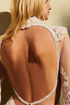 the back of a woman wearing a white dress