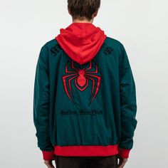 Miles Morales woven patch on the chest Embroidered patch on the back Embroidered text on the back Full front zip closure Snap side pockets Drawstring hood 100% Polyester Imported Officially licensed Marvel merchandise Aaron is wearing a medium Hooded Outerwear With Embroidered Graphics For Fall, Long Sleeve Hoodie With Embroidered Patch For Streetwear, Green Embroidered Logo Outerwear For Streetwear, Green Embroidered Streetwear Outerwear, Embroidered Green Outerwear For Streetwear, Green Embroidered Outerwear For Streetwear, Varsity Hooded Windbreaker For Streetwear, Casual Hooded Outerwear With Embroidered Patch, Hooded Winter Outerwear With Embroidered Patch