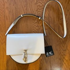 Zac Posen Belay Leather Crossbody Bag - Nwt - Adjustable Crossbody Strap - Turn Lock Closure - Interior Slip Pocket - Exterior Slip Pocket - Gold-Tone Hardware - Approximate Dimensions: 9"W X 7"H X 3"D - Leather - Color: Light Beige White Leather Crossbody Saddle Bag, Chic White Leather Saddle Bag, White Crossbody Bag With Metal Hardware, White Shoulder Bag With Metal Hardware For Travel, White Shoulder Bag With Metal Hardware, Chic White Satchel With Metal Hardware, White Shoulder Bag With Metal Hardware For Everyday, Trendy White Shoulder Bag With Metal Hardware, Chic White Crossbody Saddle Bag