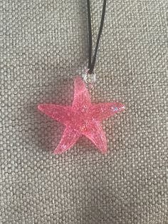 "This gorgeous resin starfish pendant is absolutely stunning. It is a small-medium sized pendant. It is strung beautifully along a black cord with adjustable rings to be between 20-22\" in length and is finished with a lobster clasp.  This can be placed on 18-20\" length if requested.  This is an absolutely gorgeous pendant and would be a great birthday present, anniversary present, Mother's Day gift, Valentine's Day present, birthday present, or graduation gift. The sleek design of this pendant will turn heads and make you take a second look! Like what you see? View more at: https://www.etsy.com/shop/StephsCraftingBits" Pink Starfish Jewelry For Gift, Adjustable Necklace With Starfish Charm As Gift, Adjustable Starfish Charm Necklace As Gift, Adjustable Starfish Charm Necklace For Gift, Pink Star-shaped Jewelry With Starfish Charm, Pink Star Jewelry With Starfish Charm, Star-shaped Resin Jewelry For Gifts, Star Shaped Resin Jewelry Gift, Beach Theme Jewelry