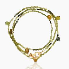 Gold & Stone Bracelet - A graceful array of micro-faceted gemstone beads make this elegant and versatile bracelet perfect for everyday wear. Triple-wrapped and long enough to be worn as a necklace, its a perfect blend of subtle sparkle and classic sophistication in green tourmaline. Springring clasp closure.<br><br>Size 6 wrist: order 19.5<br>Size 7 wrist: order 22.5<br>Size 8 wrist: order 25.5<br> Elegant Multi-strand Faceted Beads Bracelets, Elegant Multi-strand Beaded Bracelets With Faceted Beads, Elegant Wrap Bracelet With Natural Stones, Elegant Multi-strand Polished Beaded Bracelets, Elegant Wrap Bracelet With Round Natural Stones, Elegant Wrap Bracelet With Faceted Beads, Elegant Multi-strand Bracelet With Faceted Beads, Elegant Multi-strand Gemstone Beaded Bracelets, Elegant Double Strand Faceted Beaded Bracelets