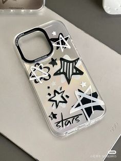 an iphone case with various stickers on it sitting on top of a white surface