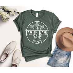 Custom Family Farm Name Shirt, Gift For Farmer, Custom Farming Est Date Tee, Personalized Farmer Shirt, Farm Life Gifts, Farmer Face Line Black design for Athletic Heather, White, Baby Blue, Pink, Orange, Heather Peach, Yellow, Banana Cream, and Desert Pink. White design for all other colors Premium quality printed in the USA. Free Shipping on orders over $35 (US only) Printed in the USA High quality, durable shirts, sweatshirts, hoodies etc. A B O U T U S We offers custom t-shirts for any occasion! Whether it is a birthday, engagement, bachelor party, or a gender reveal celebration, we have you concerned. Check out our funny t-shirts that can make great gifts! For custom work or special requests, please contact us! D E T A I L S * 100 % Handmade * Combed with cotton and poly graphic tee f Relaxed Fit Short Sleeve Tops For Family Gatherings, Casual Tops With Custom Print For Family Gatherings, Cotton Short Sleeve Shirt For Family Gatherings, Short Sleeve Tops With Name Print For Family Gatherings, Cotton Tops With Name Print For Family Reunion, Summer Short Sleeve Tops For Family Gatherings, Summer Tops For Family Gatherings With Short Sleeves, Summer Tops With Short Sleeves For Family Gatherings, Life Gifts