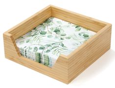 an empty bamboo box with green leaves on it