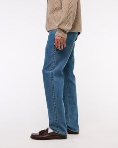 Our 90's Straight jeans that are relaxed through the thigh with a straight leg and a slightly higher rise in our vintage stretch fabric and broken-in denim feel. Paying homage to a fit that captures the essence of 90's authenticity through washes and fabrics, this is the kind of denim that you dream about finding in a thrift store! Features a dark wash and clean hem. Classic Mid-rise Rigid Denim Bottoms, Classic Medium Wash Jeans For Fall, Classic Medium Wash Rigid Denim Bottoms, Classic Recycled Denim Bottoms For Spring, Classic Jeans With Standard Cut For Fall, Classic Straight Denim Bottoms, Retro Jeans For Everyday Wear, Classic Flare Jeans For Fall, Classic Relaxed Fit Denim Bottoms