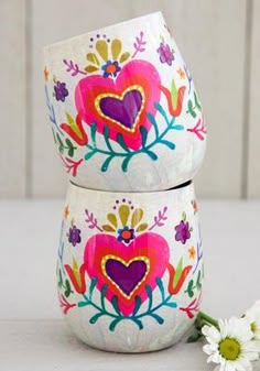 two white bowls with hearts painted on them