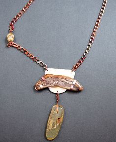 One of a kind OOAK  handmade jewelry created by Mary Heuer in her Wisconsin studio. Petrified wood is tab set in copper with a 1/1/2 inch long amber dangle hanging below and is finished off with copper chain.  This casual piece slips over your neck and measures approximately 28 inches long including the dangle.  Fun.  This necklace was originally priced at $125, now reduced to $95. All of my one of a kind necklaces and bracelets are shipped USPS Priority Mail within 1-5 days after receipt of pay Bohemian Brown Electroformed Necklaces, Brown Natural Stone Pendant Jewelry, Artisan Jewelry With Natural Stones And Copper, Artisan Copper Jewelry With Natural Stones, Handmade Rustic Agate Jewelry, Handmade Jasper Gold Jewelry, Handmade Gold Jasper Jewelry, Artisan Jewelry With Natural Stones In Brown, Rustic Agate Jewelry For Healing