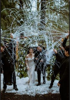 the bride and groom are surrounded by confetti as they walk through the snow