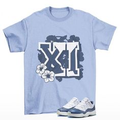 Floral Throwback Jordan 11 Low Diffused Blue Woman's Sneaker Matching Tee Shirt Blue This classic unisex jersey short sleeve tee fits like a well-loved favorite. Soft cotton and quality print make users fall in love with it over and over again. These t-shirts have-ribbed knit collars to bolster shaping. The shoulders are tapered for a better fit over time. Dual side seams hold the garment's shape for longer.  .: Made with 100% Airlume combed and ring-spun cotton, a lightweight fabric (4.2 oz/yd² Light Blue Short Sleeve T-shirt With Graphic Print, Light Blue Short Sleeve Pre-shrunk Shirt, Blue T-shirt With Sublimation Print For Streetwear, Blue Sublimation Print T-shirt For Streetwear, Light Blue Letter Print T-shirt, Blue Graphic Tee Shirt With Sublimation Print, Light Blue Letter Print T-shirt With Short Sleeves, Light Blue T-shirt For Spring Streetwear, Light Blue Letter Print Short Sleeve T-shirt