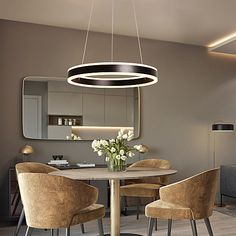 a dining room table with four chairs and a round light fixture hanging from the ceiling