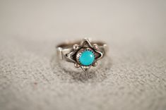 I am offering you this vintage sterling silver wedding band stacker design ring.  This features a raised relief single stone setting with beautiful detailing.  This has a prong set round shaped genuine Turquoise stone set in it.  This ring is currently a size 4 3/4, though I am sure it could be sized up or down. Please review all of my pictures, as they are all a very important part of , my listing/descriptions. Vintage Turquoise Promise Ring, Turquoise Vintage Promise Ring, Wedding Stackable Turquoise Ring In Sterling Silver, Sterling Silver Stackable Turquoise Ring For Wedding, Stackable Sterling Silver Turquoise Ring For Wedding, Heirloom Turquoise Ring In Sterling Silver For Anniversary, Heirloom Sterling Silver Turquoise Ring For Anniversary, Vintage Silver Turquoise Ring For Wedding, Turquoise Ring Stamped 925 For Wedding