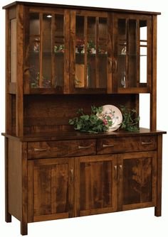 a wooden hutch with glass doors and drawers on it's sides, in front of a white background