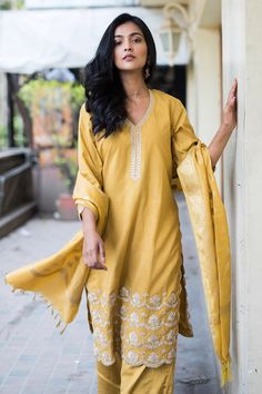 Yellow cotton embroidered kurta in gota work. Paired with solid pant and dupatta.
Component: 3
Pattern: Embroidered
Type Of Work: Gota work
Neckline: Leaf neck
Sleeve Type: Three quarter
Fabric: Cotton, Cotton Silk, Banarasi
Color: Yellow
Other Details: 
Banarasi dupatta
Scallop hem kurta
Occasion: Reception,Wedding - Aza Fashions Unstitched Straight Kurta Palazzo Set With Gota Work, Diwali Straight Kurta Palazzo Set With Gota Work, Eid Gota Work Churidar, Diwali Palazzo Set With Gota Work On Straight Kurta, Straight Kurta Churidar With Resham Embroidery In Slub Silk, Mulmul Palazzo Set With Zari Work And Straight Kurta, Eid Chanderi Unstitched Suit With Gota Work, Eid Gota Work Chanderi Unstitched Suit, Designer Wear Unstitched Suit With Gota Work