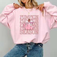 This super-soft fleece-lined Coquette Pumpkin Season Sweatshirt features a cute pumpkin and coquette pink bow. Printed on Gildan unisex sweatshirts for the ultimate in cozy comfort. Made for for those chilly days of the fall season! Please check the size charts for the perfect fit. Details: ✔ 50% ethically grown cotton, 50% polyester ✔ Medium-heavy weight fabric for the perfect amount of warmth ✔ Premium DTG prints - no peeling or cracking ✔ Classic fit in your regular size ✔ Easy care: Machine Pink Sweatshirt For Fall Loungewear, Cute Fall Letter Print Sweatshirt, Cute Letter Print Sweatshirt For Fall, Cute Fall Loungewear Sweatshirt, Cute Pink Fall Sweatshirt, Pink Crew Neck Sweatshirt For Fall, Coquette Pumpkin, Girly Halloween, October Outfits