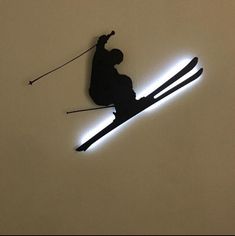 the silhouette of a skier is shown on the wall