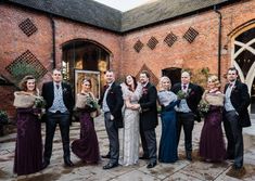 a group of people standing next to each other in front of a red brick building