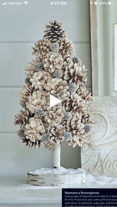 a pine cone christmas tree sitting on top of a table