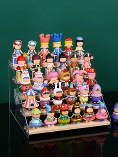 a group of toy figurines sitting on top of a wooden table next to each other