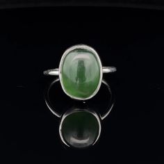 * Sterling Silver ring with Nephrite Jade  * The face of this ring measures 14mm X 13mm * This ring is size 7 * You will receive the exact ring pictured. Classic Green Opal Cabochon Ring, Green Oval Opal Ring With Polished Finish, Modern Oval Jade Ring, Green Oval Cabochon Gemstone Signet Ring, Green Signet Ring With Oval Cabochon Gemstone, Green Oval Cabochon Signet Ring, Jade Oval Cabochon Rings With Polished Finish, Jade Rings With Polished Finish, Oval Cabochon, Jade Rings With Polished Finish In Oval Cabochon Shape