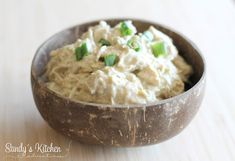 a wooden bowl filled with food on top of a table