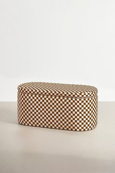 a brown and white checkered box sitting on top of a table