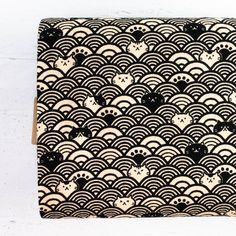 a black and white pattern on a piece of wood