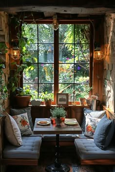 a living room with two couches and a table in front of a large window