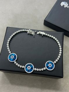 Silver Evil Eye Bracelet , Blue Stone Bracelet , Handmade Jewelry Bracelet , Good Luck Bracelet , 925K Sterling Silver Jewelry ,Gift For Him .. ★Item Details * Material : 925K Sterling Silver * Total weight : 12 Grams * Length : 18 Cm ✔ Ready to Ship in 1-2 Business Days .. ✔ Shipped to the Worldwide 1-5 business days with free shipping... ✔ The product will be sent to you with a handmade wooden box to avoid any damage during shipping... ✔ Visit our store, browse other Men's jewelry, silver and Blue Sterling Silver Bracelets, Blue Sterling Silver Round Bracelets, Blue Hand-set Tennis Bracelet As Gift, Blue Hand-set Tennis Bracelet For Gift, Adjustable Blue Round Tennis Bracelet, Blue Diamond Bracelet With Hand Set Stones, Blue Hand Set Diamond Bracelet, Blue Hand Set Round Diamond Bracelet, Adjustable Blue Tennis Bracelet