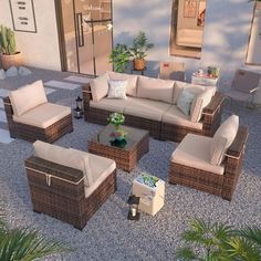 an outdoor living area with wicker furniture and potted plants on the side walk