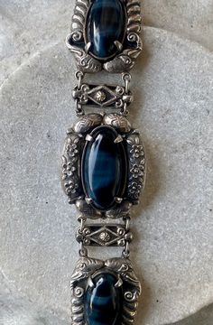 Stunning Blue Tigers Eye Chinese Ornate Sterling Silver Vintage Link Bracelet This bracelet is most amazing ! The stones are incredible, Silver work is stunning ! Solid in weight measures 7 inches in lenght See pictures next to ruler for scale Elegant Blue Oyster Bracelet, Bohemian Blue Oval Bracelet, Vintage Blue Oval Bracelets, Vintage Blue Oval Bracelet, Antique Blue Bracelet Jewelry, Vintage Blue Bracelet For Formal Occasions, Indie Jewelry, Usa Jewelry, Blue Tigers