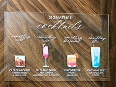 a glass sign with different types of cocktails on it and the names of each drink