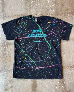 Spruce up your wardrobe with this stylish and meaningful New Creation (Splatter) Adult Box T-Shirt! This christian apparel features bold words of encouragement for you to remind yourself who you are, and the boxy design offers a clean look that spruces up any outfit. Wear it proud and be a walking, talking representation of the new creation you are! Black Cotton T-shirt With Paint Splatter, Relaxed Fit Paint Splatter T-shirt With Crew Neck, Casual Relaxed Fit Paint Splatter T-shirt, Casual Multicolor Paint Splatter T-shirt, Multicolor Paint Splatter Casual T-shirt, Streetwear Cotton Tops With Paint Splatter, Casual Crew Neck T-shirt With Paint Splatter, Cotton Paint Splatter Tops For Streetwear, Relaxed Fit Cotton T-shirt With Paint Splatter