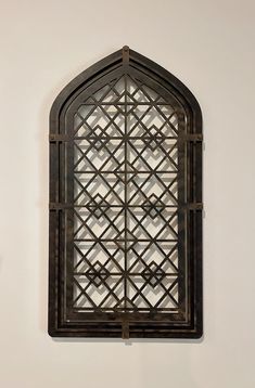 an ornate window is mounted on the wall