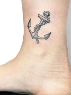 a small anchor tattoo on the ankle