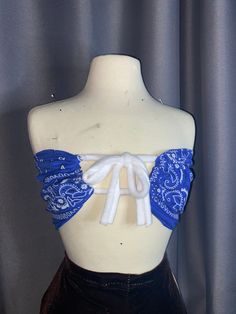 a mannequin wearing a blue and white bra with laces on it's back